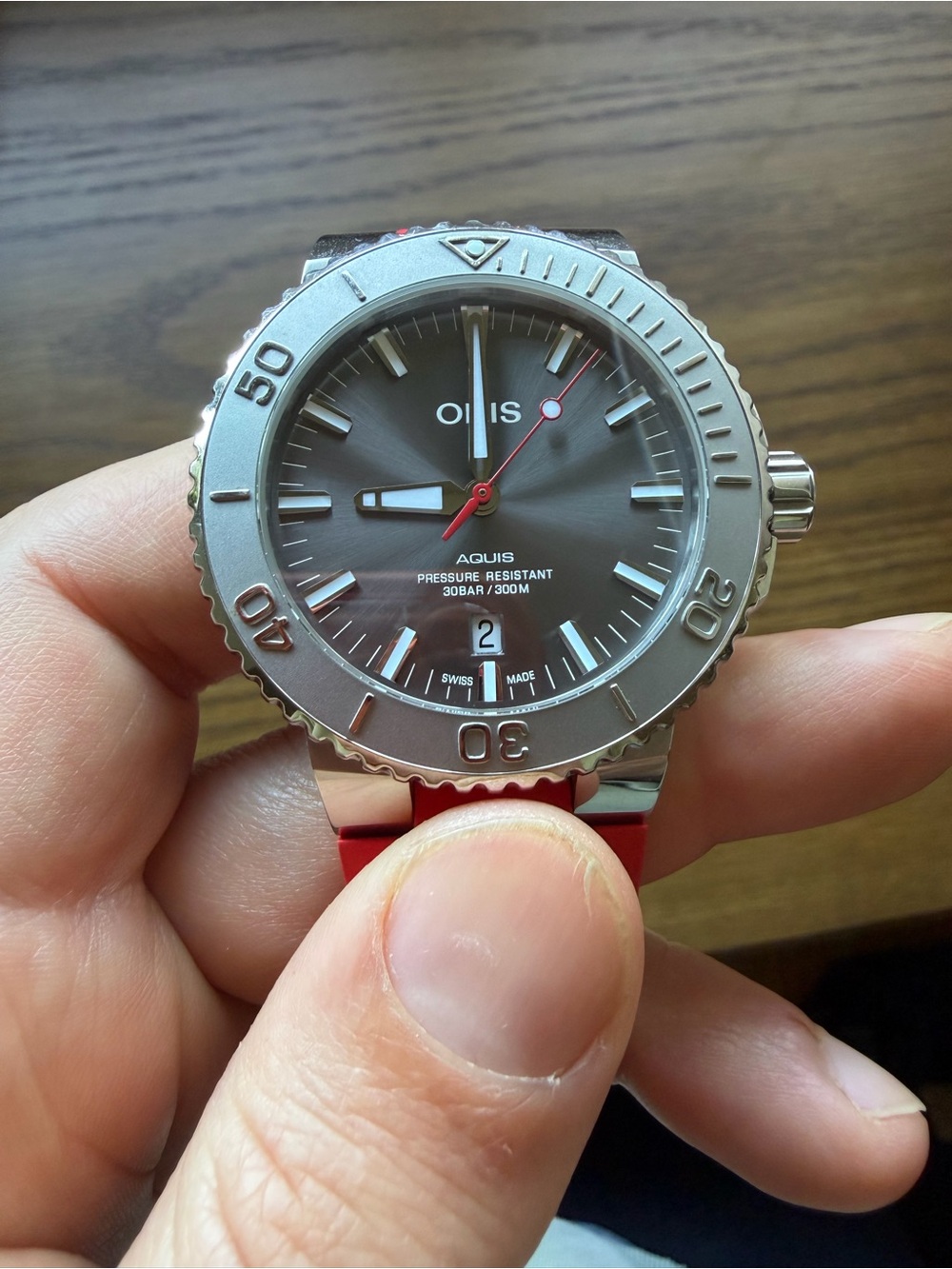 Oris Aquis Date w/ relief bezel, gray dial, red strap and stainless steel band